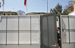 Turkish soldier opens door in temporary wall by UN buffer zone on Turkish-Cypriot side of Nicosia. Photo: AP