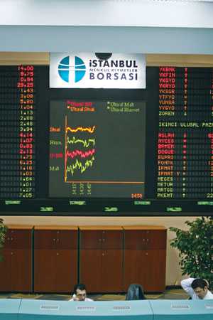Traders work at the Istanbul Stock Exchange building in this file photo. The ISE index has recently hit a record high of 70,000 points.
