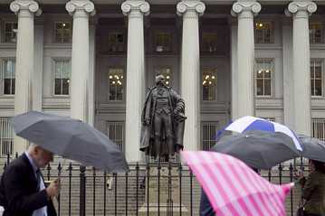 Bloomberg News  Pedestrians walk past the U.S. Treasury Department.