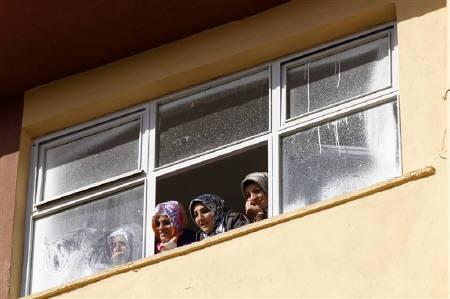 Women watch a campaign event from a window in Kozluk, a town in the southeast province of Batman, April 21, 2011.  Credit: Reuters/Umit Bektas