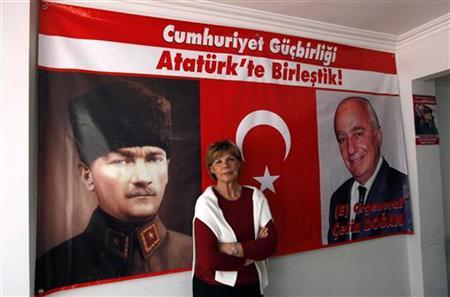 Nilgul Dogan, wife of retired General Cetin Dogan, poses in front of her husband's election campaign banner at the campaign office in Istanbul May 25, 2011.  Credit: Reuters/Murad Sezer