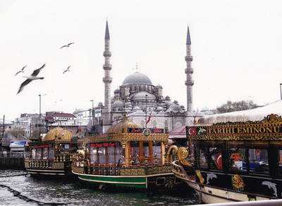Arty Boats tied up at Eminonu on the Bosphorus with Mosque in the background. Minarets were...