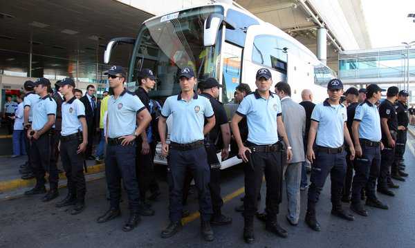 Associated Press  Riot police officers surrounded a bus Wednesday as Maccabi Tel Aviv soccer players arrived at Ataturk Airport in Istanbul. 