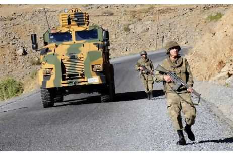 Turkish soldiers patrol a road in Hakkari province on October 22. Turkish troops killed some 250 Kurdish militants in the country's south-east last month in retaliation for the death of 24 soldiers.