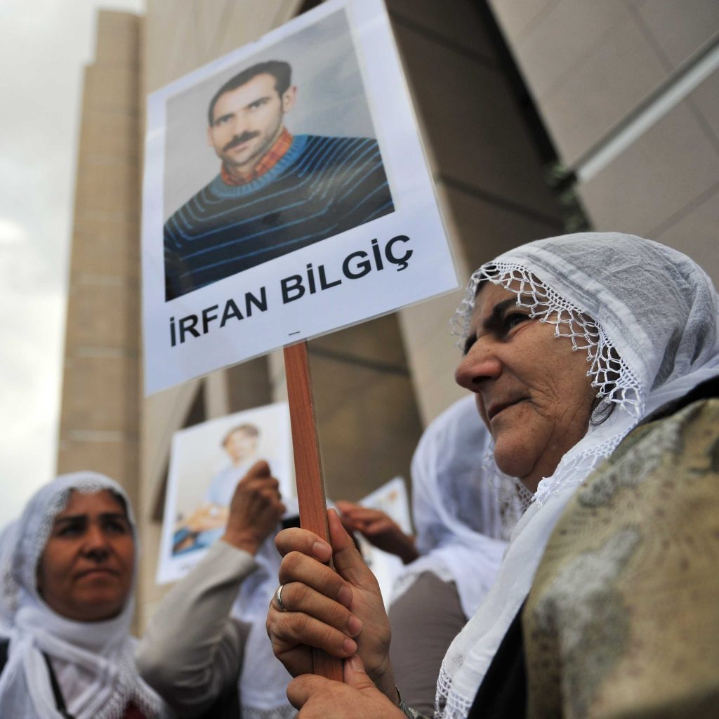 Kurdish women hold pictures of jailed journalists in Istanbul on Sept. 10, during the start of the trial of 44 journalists with suspected links to rebels from the Kurdistan Workers' Party. (AFP/Getty Images)