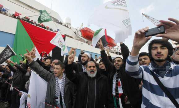 Supporters of Hamas' Gaza leader Ismail Haniyeh shout slogans against Israel in front of the cruise liner Mavi Marmara in Istanbul